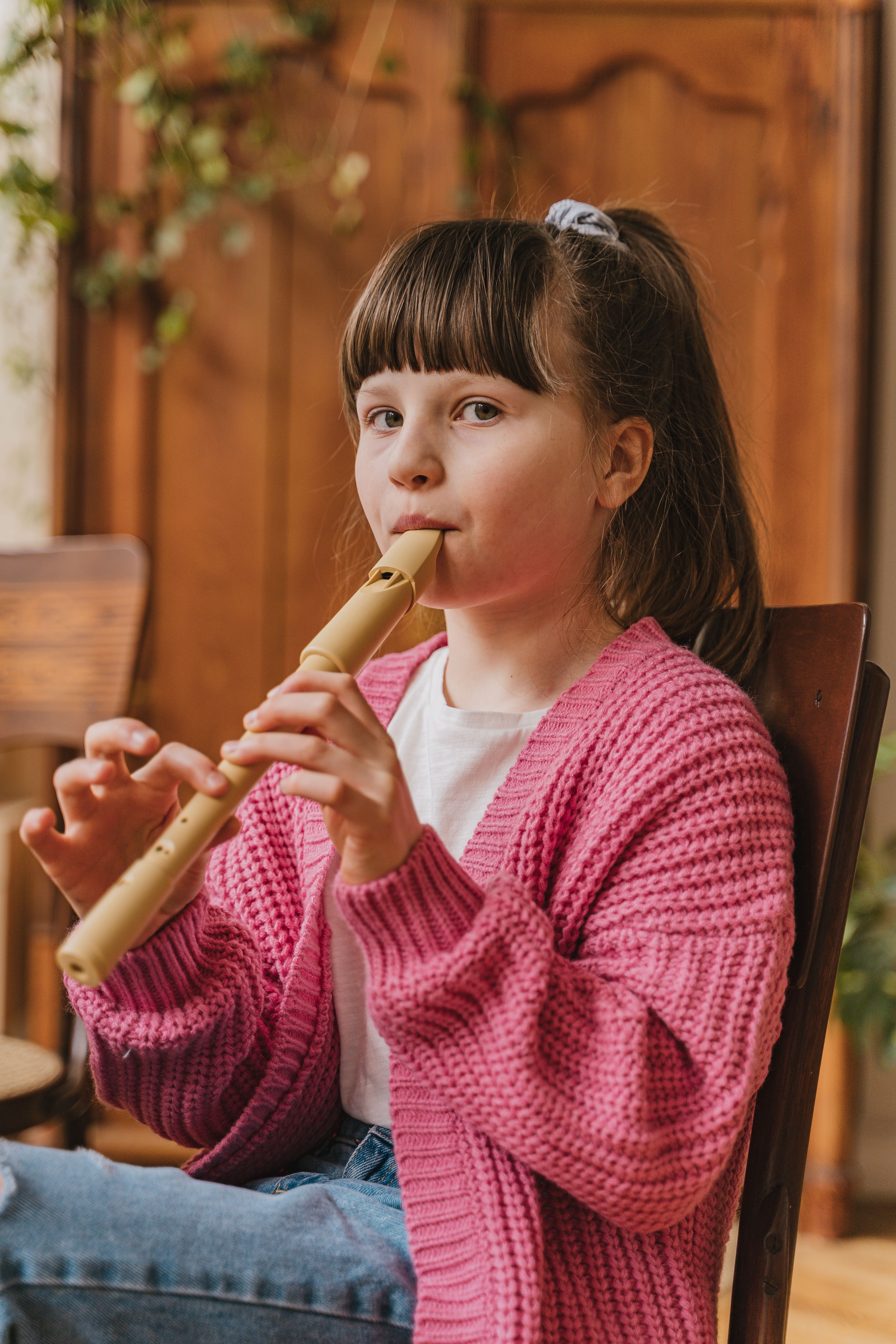 Girl playing the flute as part of a school music and arts enrichment programme
